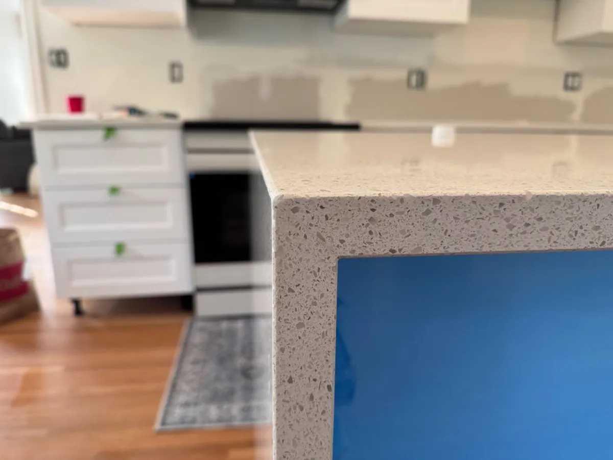 Finished quartz countertop with a crisp mitered edge in a customer kitchen